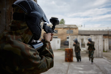 Fototapeta premium A Soldier is taking aim while teammates advance during tactical field training