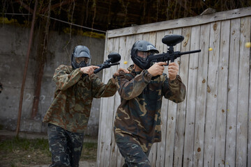 Fototapeta premium An armed group of several people practice with weapons on a training field outdoor