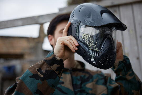 A man soldier is wearing his defensive helmet at the battlefield