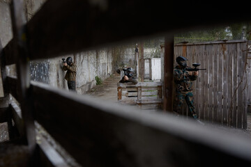 Fototapeta premium Hidden view of soldiers aiming at a target on a training field, leveling their weapons