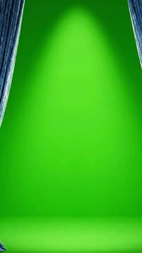 Opening light blue curtain on green background in a studio setting
