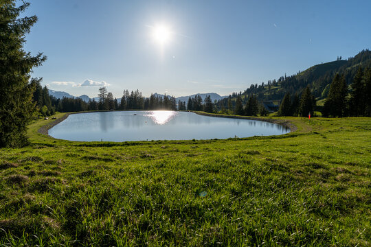 Sunny alpine lake at Seealpe on Nebelhorn mountain in Germany