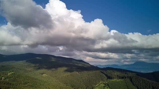 Aerial Hyperlapse Forward Flight With Yaw Over Mountain Forest Cumulus Clouds Summer