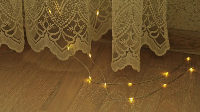 Vintage home aesthetics, warm garland lights and lace curtain corner