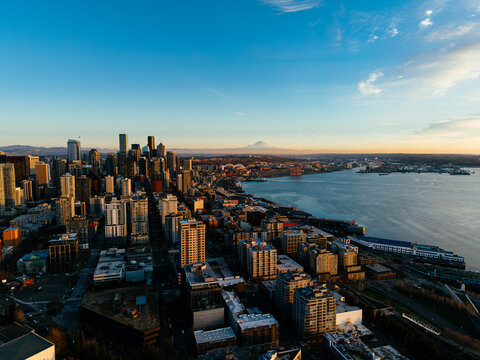 Seattle skyline and Elliott Bay with Mount Rainier at sunset, Washington, USA aerial view. g.