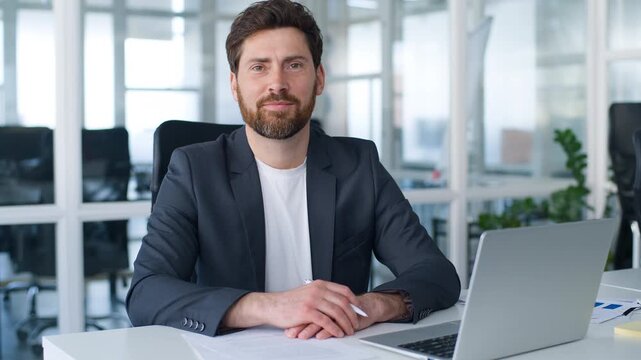Caucasian mature business man signing contract smiling at camera happy middle-aged businessman 40s male company CEO writing in report document smile cheerful employer write paperwork working in office