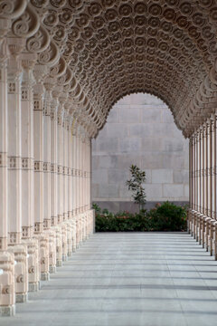 Symmetry and tradition define the ornate stone architecture of a sacred temple walkway.