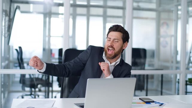 Happy excited Caucasian middle-aged business man dancing working laptop having fun celebrate online win at office smiling cheerful mature businessman dance at table with computer male moving to music