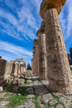 Ruins of an ancient temple at an archaeological site in Cyrene, Libya showcasing historical columns under blue skies