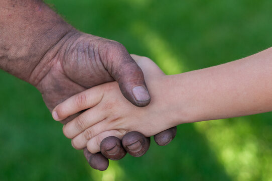 Adult and Child Shaking Hands as a Symbol of Partnership and Trust
