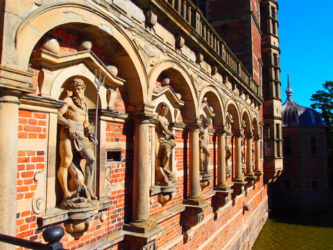  Detailed classical statues on brick wall of historic building