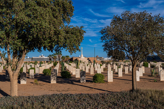 British World War 2 cemetery in Tobruk with graves and a cross under the sky in Libya