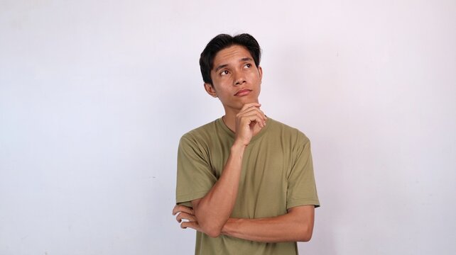 Asian young man thinking expression gesture holding chin