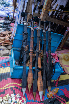 Swords for sale in market stall in Port Sudan showcasing local craftsmanship and trading activity