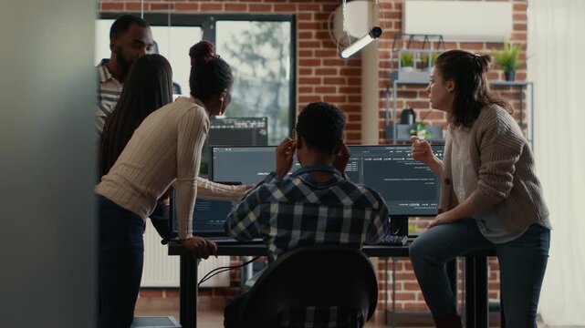 Software development team analyzes compiling issues on shared screens, using collaborative review to identify errors in a development workflow