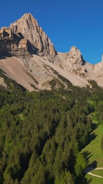 Aerial panning view of Devoluy Massif in Vercors Park. La Jarjatte Valley with mountain peaks and forest. Drome, French Alps, France