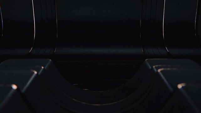 Driving dark ribbed panels into rolling crests by motor in enclosed dark chamber, with copper seams