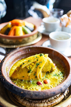 Experience traditional Moroccan tajine served with couscous on a dining table in a local setting