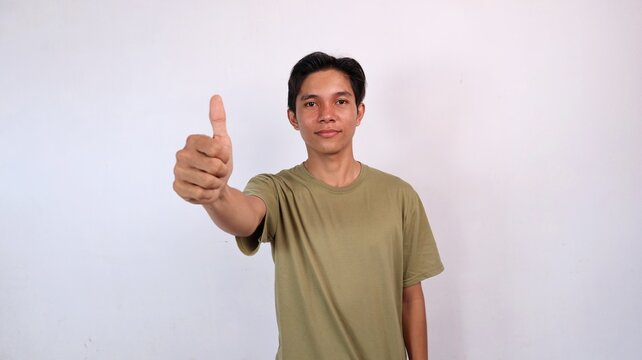 young asian man giving thumbs up