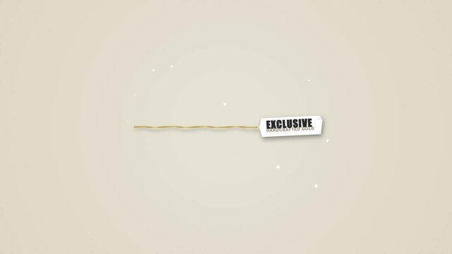 Golden thread unrolls revealing a handcrafted jewelry label on white