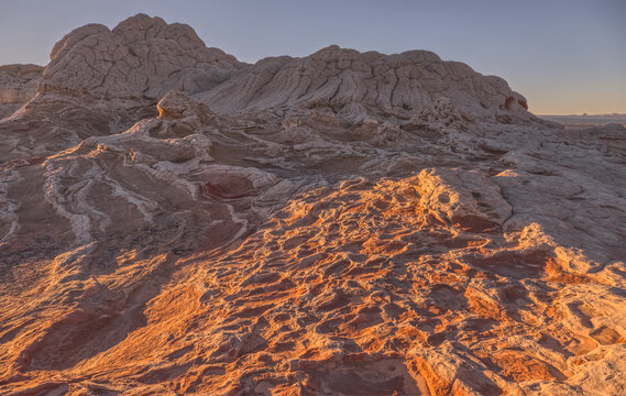 Colorful sandstone formations create unique landscapes at White Pocket in Vermilion Cliffs National Monument during sunset