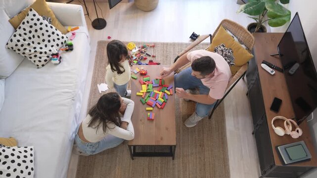 Top view of family playing with building blocks together