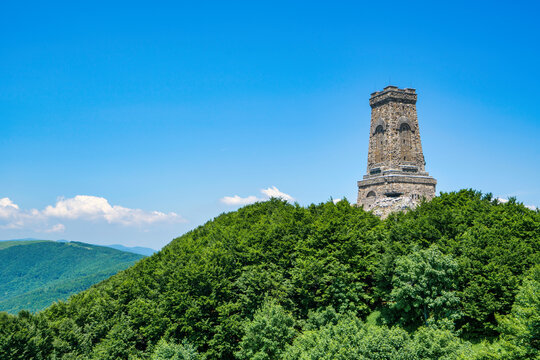 Stone tower at Shipka Monument stands against blue sky in Bulgaria's Stara Zagora region