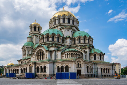 Golden domes and green roofs of Saint Alexander Nevsky Cathedral stand tall in Sofia amidst a clear sky