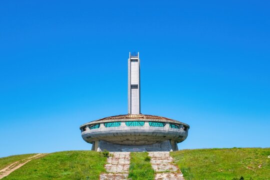 Buzludzha Monument stands as a historic symbol of communism in Bulgaria surrounded by clear blue skies