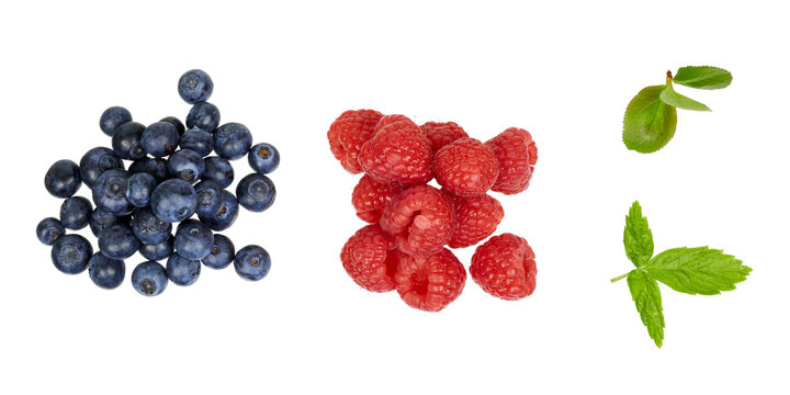 pile of blueberries and raspberries with fresh leaves isolated on white or transparent png