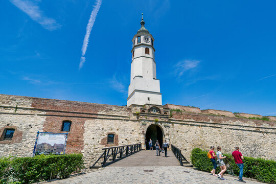 Visitors approach the entrance of Sahat Kula clock tower at Belgrade Fortress on a sunny day in Serbia