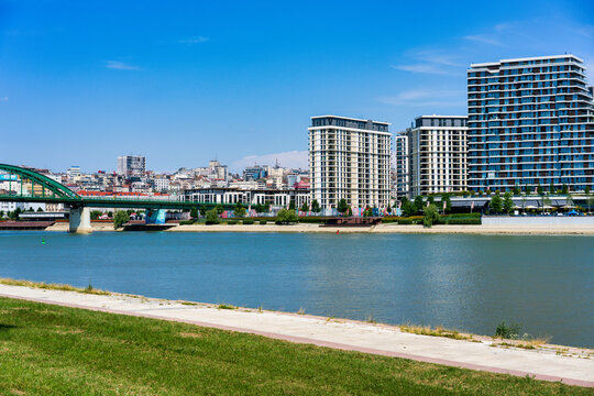 Belgrade skyline features modern buildings along the Sava River in Serbia with clear skies