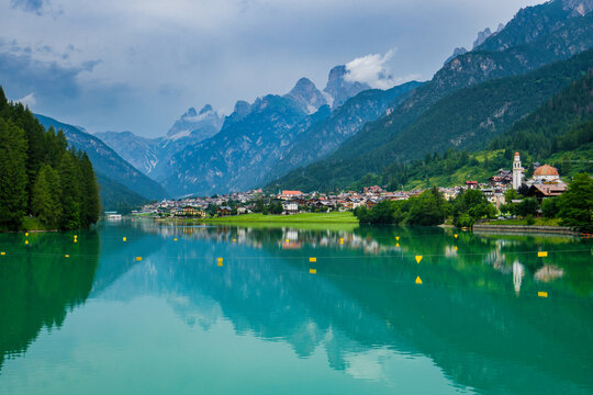Mountain reflections on emerald waters of Lake Auronzo in Veneto, Italy
