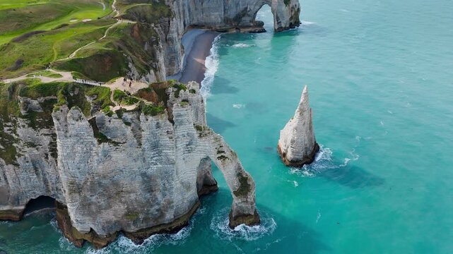 Landmark coastal scenery of Etretat, Normandy, France, with chalk cliffs attracting visitors to iconic French travel destination.