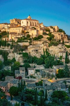 Houses of Gordes on hillside during sunset in Provence, France, showcasing historic architecture and natural beauty