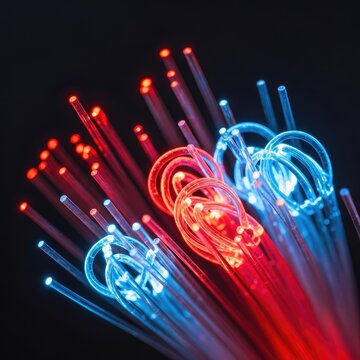 Close-up of glowing optical fiber cables with vibrant red and blue light strands transmitting high-speed digital data for global internet, background, digital, electronic