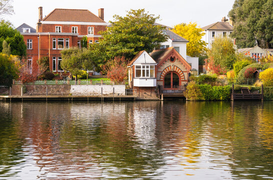 Reflections of riverside houses along the River Thames in Kingston upon Thames in London on a clear day
