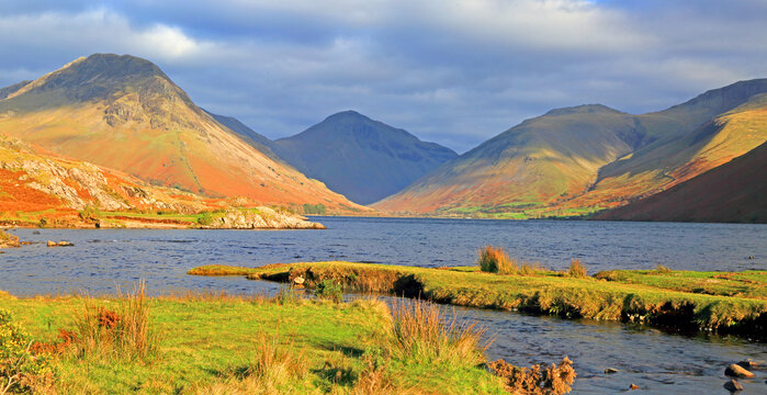 Great Gable and Kirk Fell rise above Wastwater under changing skies in Lake District, Cumbria, England