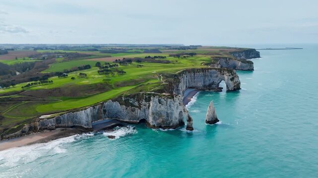 Panoramic drone view of Etretat cliffs on French coast in Normandy. Chalk coastline and rock formations above sea