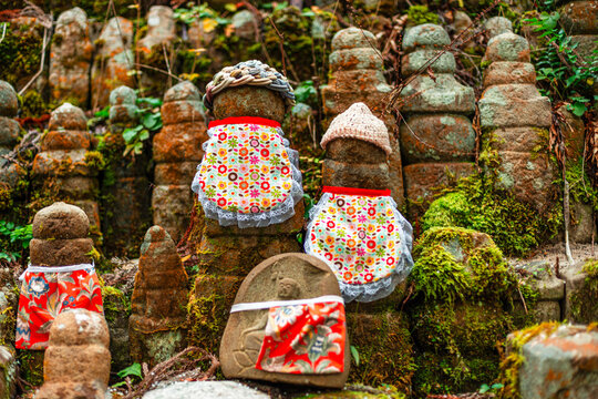 Rows of Jizo statues in colorful bibs at Okunoin Cemetery in Japan guarding children and travelers