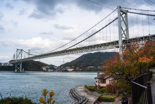 Scenic view of Kanmon Bridge connecting Kitakyushu and Shimonoseki in Japan under cloudy skies