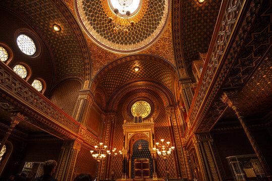 Golden dome with arabesque patterns inside a historic synagogue in Prague