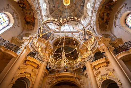Interior view of St. Nicholas Church in Mal Strana with ornate chandelier and Baroque frescoes in the heart of Prague