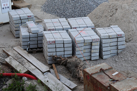 Stacked Granite Kerbstones on Pallets at Construction Site