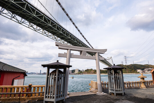 Torii gate and lanterns at Mekari Shrine beside Kanmon Bridge in Kitakyushu, Fukuoka Prefecture Japan