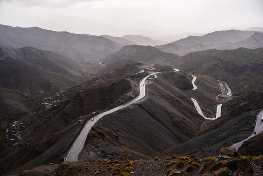 Curving road through the slopes at Tizi nTichka Pass on a cloudy afternoon in Morocco's Atlas Mountains