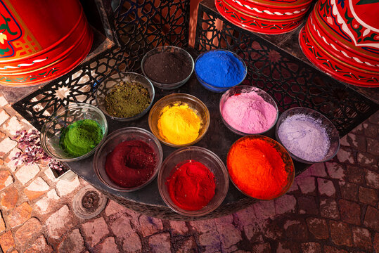 Bowls hold colorful powdered pigments for dyeing fabrics in Marrakesh market