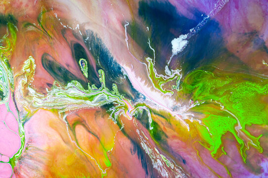 Bright colors mixed together in abstract design on canvas