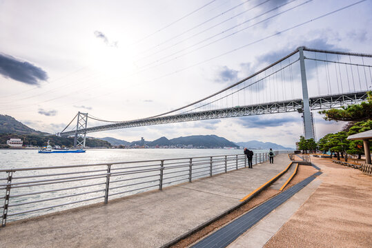 View of Kanmon Bridge from Moji waterfront promenade in Kitakyushu showcasing the connection between Kyushu and Honshu