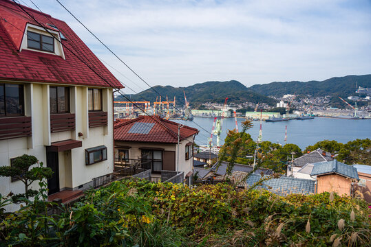 Rooftops and harbor views in Nagasaki illustrate the city's unique layout and landscape features on a clear day
